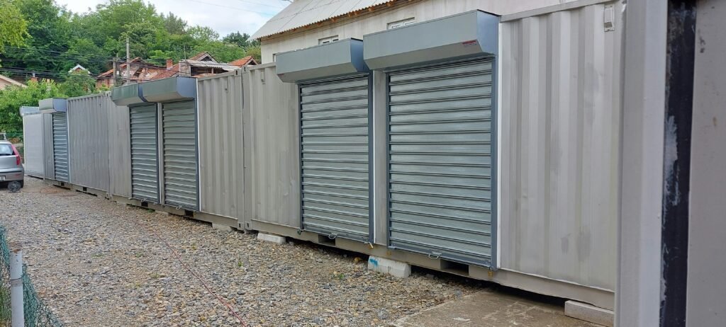 a long row of storage containers sitting on the side of a road