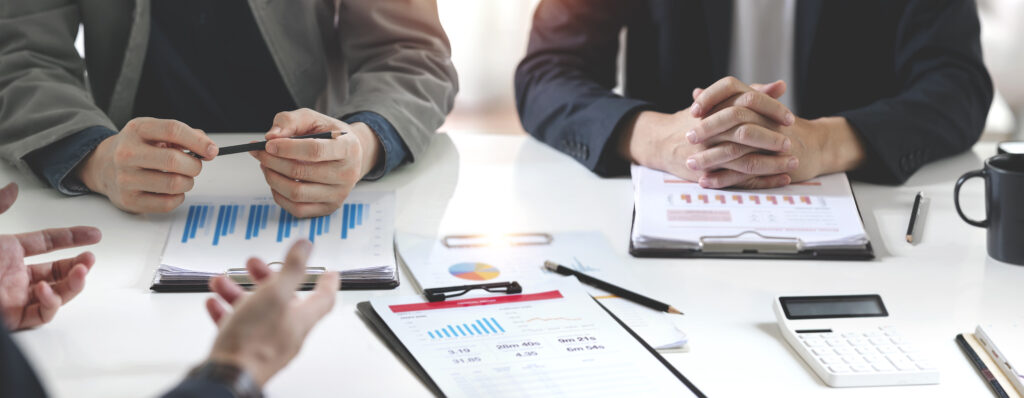 Diverse coworkers analyzing commercial business financing strategy in boardroom