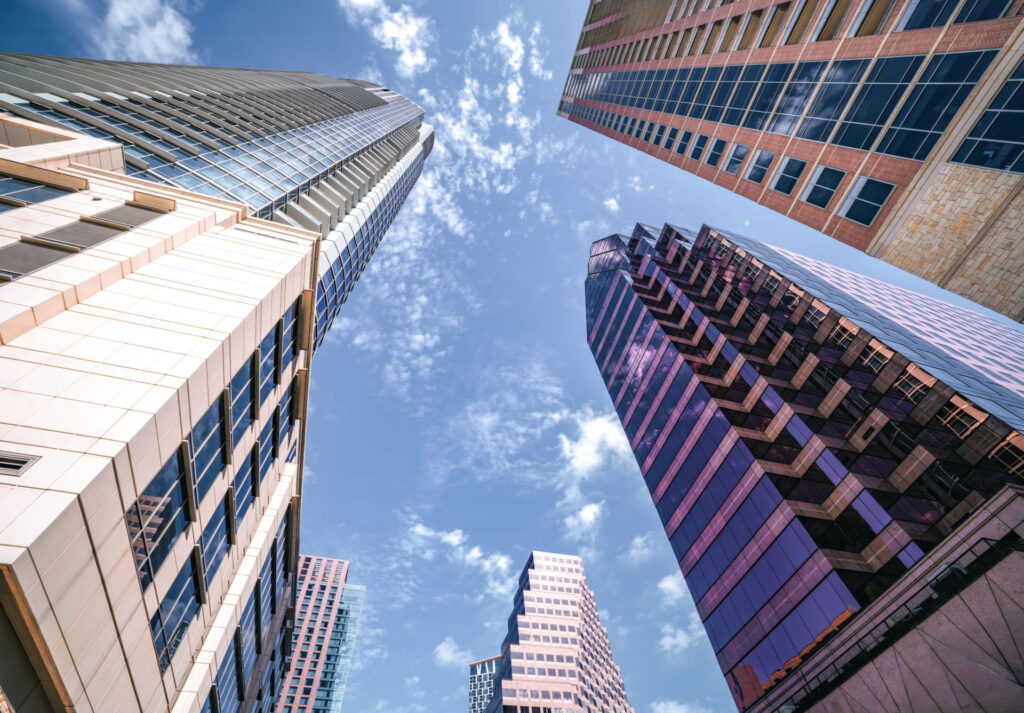 Commercial towers framing a blue sky for SBA 504 Green Leverage & Financing Fee Advantages for Commercial Real Estate