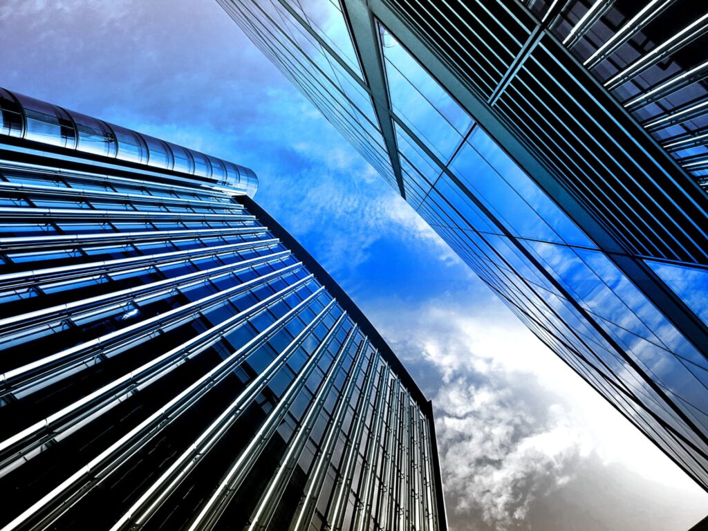 Modern glass office towers viewed from street level for Mixed-Use Property SBA Financing Guidelines