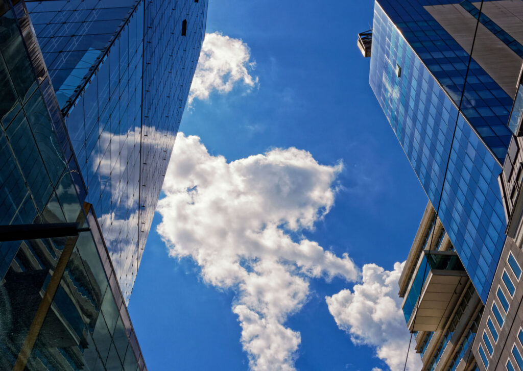 Contemporary glass office buildings beneath a bright sky for Commercial Mortgage Loans: Strategies & Financing Guide