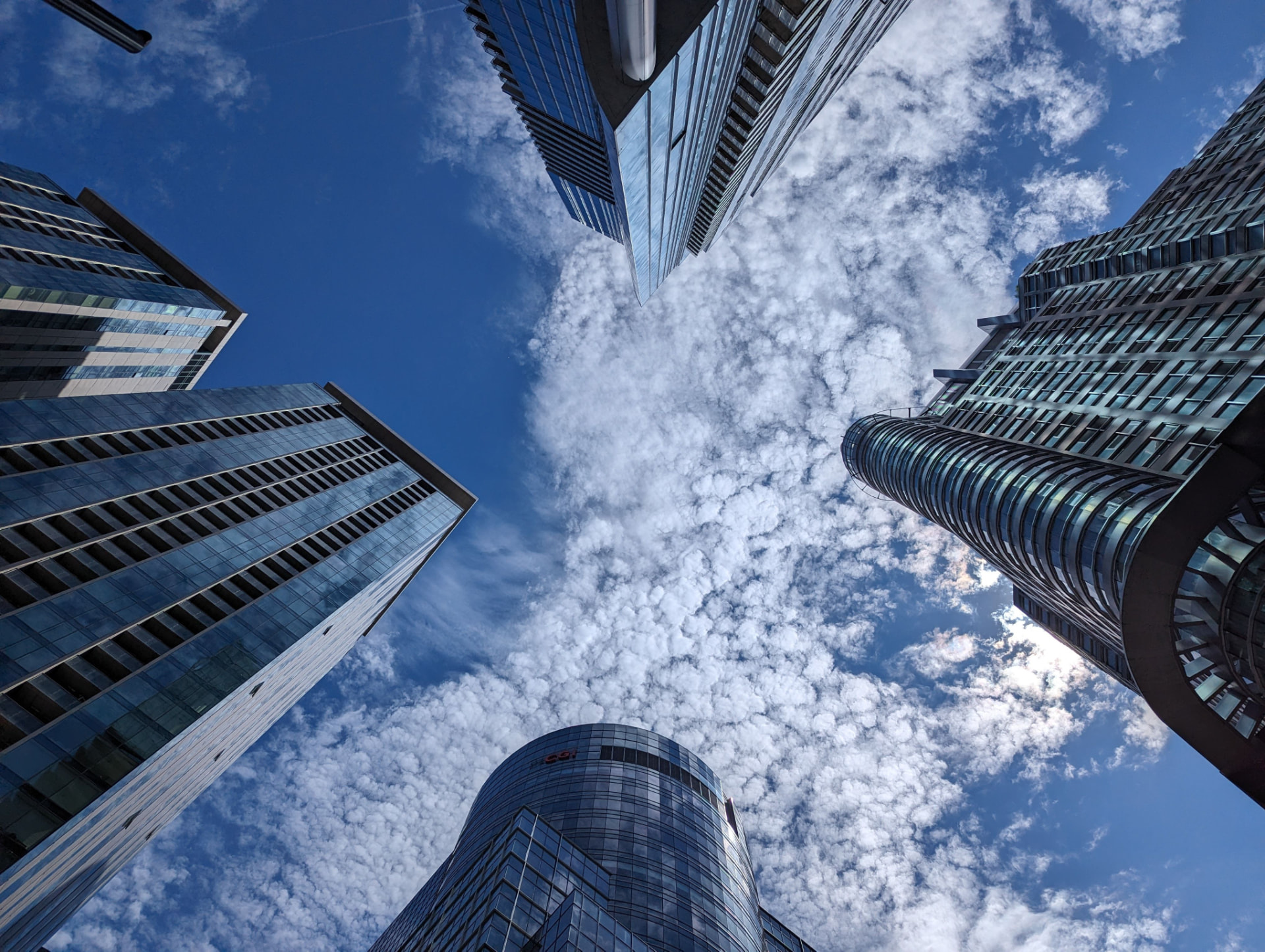 Downtown skyscrapers surrounding a cloud-filled sky for Commercial Mortgage Broker Referral Commission Structures: A Complete