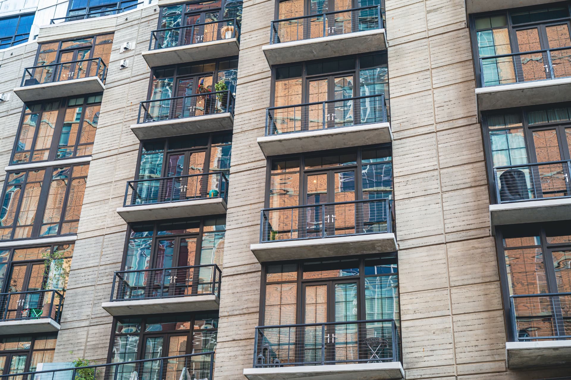 Modern multifamily building with glass-fronted balconies for Preferred Lender SBA 7(a) Loan Processing Timeline: A Complete G