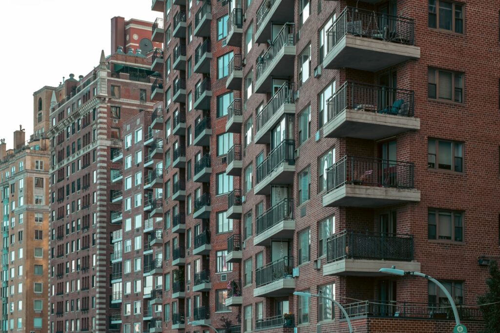 Urban brick apartment buildings with private balconies for CRE Loan Down Payment Guide & SBA Financing | Thorne CRE