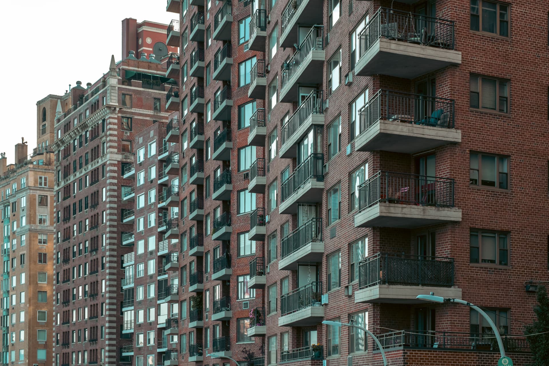 Urban brick apartment buildings with private balconies for CRE Loan Down Payment Guide & SBA Financing | Thorne CRE