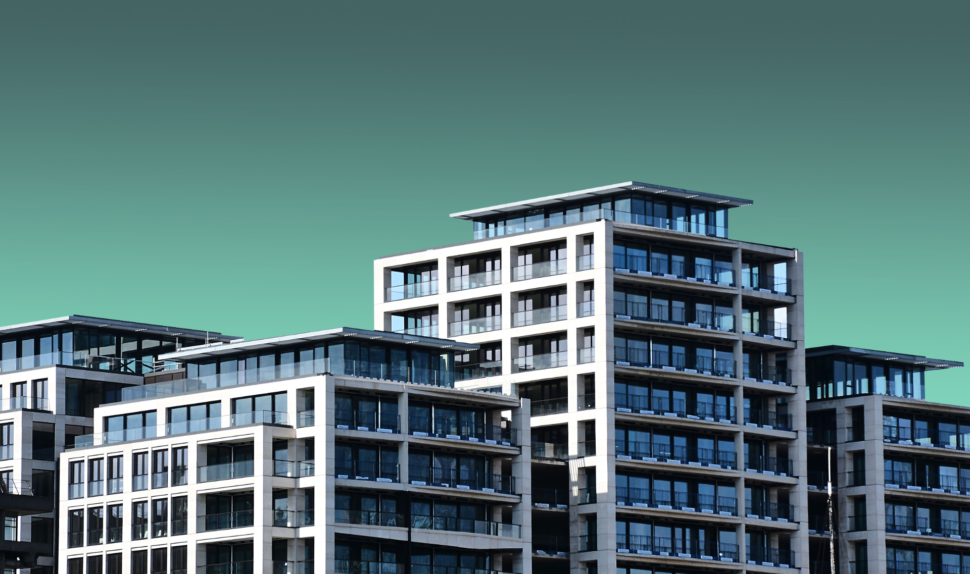 Contemporary multifamily complex with glass balconies for After-Repair Value (ARV) in Commercial Real Estate