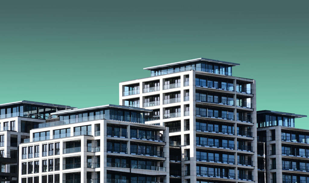 Contemporary multifamily complex with glass balconies for Financing Healthcare Facilities: Guide & CRE Insights
