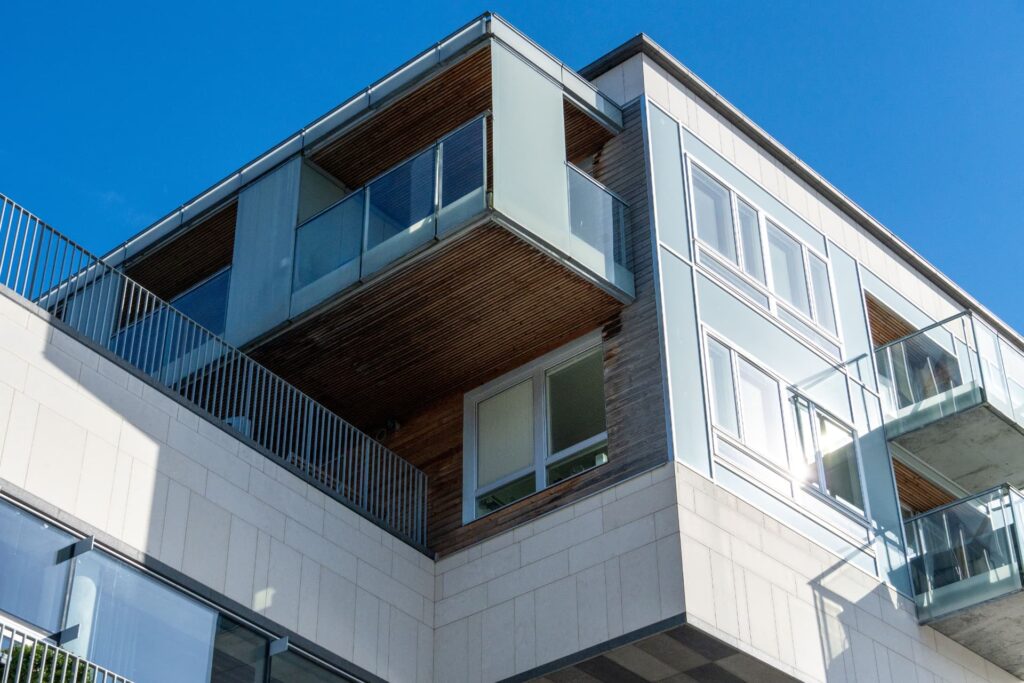 Modern apartment building facade with wood paneling and glass balconies for Medical Office Real Estate Financing Guide | Thor