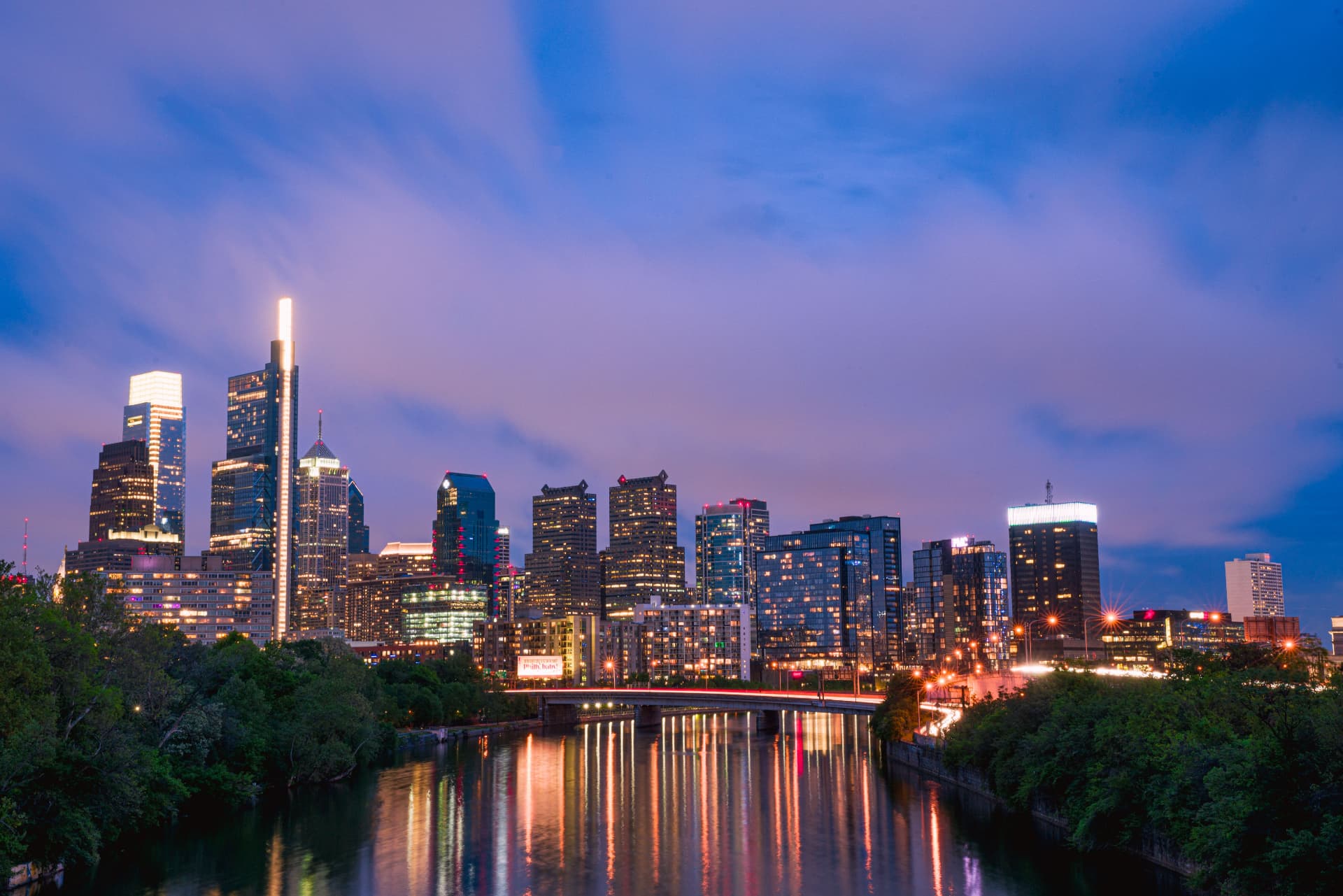 Philadelphia skyline reflected in the river at twilight for SBA 504 vs 7(a) Loans for Commercial Real Estate